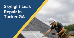 A roofer in a white hard hat and safety harness is on a dark shingled residential roof, pointing at a skylight with visible water marks and a damp rag, indicating a leak repair. The background shows suburban homes and trees under a cloudy sky. The image features a badge blue and canary yellow overlay with the title "Skylight Leak Repair in Tucker GA" in white text.