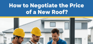A homeowner in a blue polo shirt stands thoughtfully, observing two roofers in yellow hard hats and grey overalls. One roofer points to a document on a clipboard, seemingly explaining details to the homeowner. Outside the large window, a residential house and a yellow pickup truck with roofing materials on a blue tarp are visible.